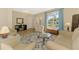 Bright living room with large window, hardwood floors and comfortable, stylish furnishings at 3335 Brooklyn Ave, Port Charlotte, FL 33952