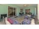 Enclosed sunroom with tile floors, ceiling fan, and furniture for relaxing at 3335 Brooklyn Ave, Port Charlotte, FL 33952