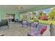 Enclosed sunroom with tile floors, ceiling fan, and furniture for relaxing at 3335 Brooklyn Ave, Port Charlotte, FL 33952