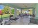 Enclosed sunroom with tile floors, ceiling fan, and furniture for relaxing at 3335 Brooklyn Ave, Port Charlotte, FL 33952
