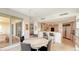 Open-concept dining area with a modern table and chairs, connecting to the kitchen and a balcony at 35 Watergate Dr # 1101, Sarasota, FL 34236