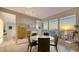 Dining area with floor-to-ceiling windows offering scenic water views, complemented by minimalist decor at 35 Watergate Dr # 1101, Sarasota, FL 34236