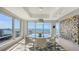 Bright dining room features a glass table, modern decor, and waterfront views at 35 Watergate Dr # 1101, Sarasota, FL 34236