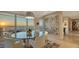 Bright dining room featuring floor-to-ceiling windows with beautiful water views and modern decor at 35 Watergate Dr # 1101, Sarasota, FL 34236