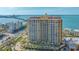 Exterior elevation of the high rise condominium in a waterfront setting with a nearby bridge at 35 Watergate Dr # 1101, Sarasota, FL 34236