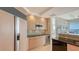 Kitchen boasting wood cabinets, stainless steel appliances, and a beverage cooler, with ocean views at 35 Watergate Dr # 1101, Sarasota, FL 34236