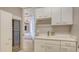 Functional laundry room with custom cabinets, a built-in wine cooler, and a modern sink at 35 Watergate Dr # 1101, Sarasota, FL 34236