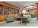Charming library with floor-to-ceiling bookshelves, comfortable seating, and soft lighting, ideal for reading and relaxation at 35 Watergate Dr # 1101, Sarasota, FL 34236