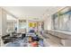 Bright living room with a leather sectional sofa, modern art, and city views at 35 Watergate Dr # 1101, Sarasota, FL 34236
