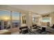 Bright living room boasts breathtaking water views through expansive windows and modern furnishings at 35 Watergate Dr # 1101, Sarasota, FL 34236