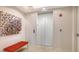 Modern lobby featuring an elevator, artistic decor, and a comfortable orange bench at 35 Watergate Dr # 1101, Sarasota, FL 34236