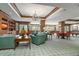 Bright lounge area featuring comfortable seating, a billiard table, and abundant natural light through large windows at 35 Watergate Dr # 1101, Sarasota, FL 34236