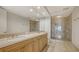 An elegant main bathroom with dual sinks, a full vanity, and a glass enclosed shower at 35 Watergate Dr # 1101, Sarasota, FL 34236