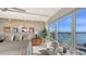 Modern main bedroom with a beautiful waterfront view and a comfortable sitting area at 35 Watergate Dr # 1101, Sarasota, FL 34236