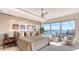 Beautiful main bedroom with a water view, tray ceiling, and stylish decor at 35 Watergate Dr # 1101, Sarasota, FL 34236