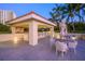 Outdoor patio with outdoor kitchen, bar, and seating areas at 35 Watergate Dr # 1101, Sarasota, FL 34236