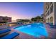 Community swimming pool with lounge chairs and sunset views at 35 Watergate Dr # 1101, Sarasota, FL 34236