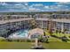 Wonderful aerial view of lakeside condo community with pool and private dock on a sunny day at 3658 Lake Bayshore Dr # 320, Bradenton, FL 34205