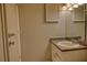 Bathroom featuring a single sink vanity, a large mirror, and a door to the left at 3658 Lake Bayshore Dr # 320, Bradenton, FL 34205