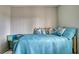 Bright bedroom featuring twin bed with blue quilted spreads and decorative pillows at 3658 Lake Bayshore Dr # 320, Bradenton, FL 34205