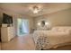 Bedroom featuring a queen bed, sliding glass doors to the outdoor patio, and white furniture at 3658 Lake Bayshore Dr # 320, Bradenton, FL 34205