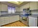 Well-lit kitchen showcasing stainless steel appliances and white cabinetry at 3658 Lake Bayshore Dr # 320, Bradenton, FL 34205