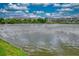 Scenic lake view surrounded by lush greenery and multiple condo buildings at 3658 Lake Bayshore Dr # 320, Bradenton, FL 34205