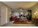 Living room with a leather sofa, area rug, ceiling fan, and dining area at 3658 Lake Bayshore Dr # 320, Bradenton, FL 34205
