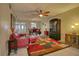 Cozy living room features a leather sofa, a ceiling fan, and an adjacent dining area at 3658 Lake Bayshore Dr # 320, Bradenton, FL 34205