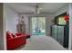 Living room area featuring a neutral carpet, ceiling fan, black cabinet, and a balcony view through sliding glass doors at 3658 Lake Bayshore Dr # 320, Bradenton, FL 34205