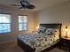 Cozy bedroom featuring large windows, ceiling fan, and decorative lamps on the nightstands at 3780 82Nd Avenue E Cir # 101, Sarasota, FL 34243