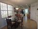 Dining area adjacent to kitchen, featuring a glass-topped table, wood chairs, and tiled floors at 3780 82Nd Avenue E Cir # 101, Sarasota, FL 34243