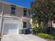 Two story home featuring a front-entry garage and well-maintained landscaping at 3780 82Nd Avenue E Cir # 101, Sarasota, FL 34243