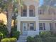 Charming two-story home featuring a balcony, well-maintained landscaping, and beautiful palm trees at 3780 82Nd Avenue E Cir # 101, Sarasota, FL 34243