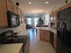 Functional kitchen featuring wood cabinets, black appliances, and tile flooring at 3780 82Nd Avenue E Cir # 101, Sarasota, FL 34243