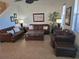 Inviting living room featuring leather seating, neutral walls, tile floors and natural light at 3780 82Nd Avenue E Cir # 101, Sarasota, FL 34243
