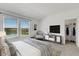 Bright main bedroom with view, styled with modern furniture and décor at 4159 Via Sienna Cir, Sarasota, FL 34243