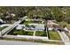 Beautiful home with a fenced yard, lush landscaping, long driveway, and many mature trees at 4218 S Lockwood Ridge Rd, Sarasota, FL 34231