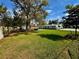 Spacious backyard featuring lush green grass, mature trees, and an outdoor seating area at 4218 S Lockwood Ridge Rd, Sarasota, FL 34231