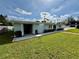 Well-maintained backyard with lush lawn, a patio area, and mature landscaping at 4218 S Lockwood Ridge Rd, Sarasota, FL 34231
