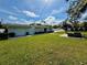 Landscaped backyard with a seating area and lush green lawn, perfect for outdoor enjoyment at 4218 S Lockwood Ridge Rd, Sarasota, FL 34231