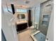 Modern bathroom boasts a glass-enclosed shower with tiled niches and a sleek double vanity at 4218 S Lockwood Ridge Rd, Sarasota, FL 34231