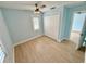 Cozy bedroom with a ceiling fan, hardwood floors, and a closet at 4218 S Lockwood Ridge Rd, Sarasota, FL 34231