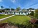 Beautiful home with a lush green lawn, mature trees, and tasteful landscaping at 4218 S Lockwood Ridge Rd, Sarasota, FL 34231