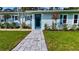 Inviting home with a stone walkway leading to a blue front door, surrounded by lush landscaping at 4218 S Lockwood Ridge Rd, Sarasota, FL 34231