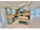 Bright kitchen featuring a center island, custom cabinets, granite countertops, and stainless steel appliances at 4218 S Lockwood Ridge Rd, Sarasota, FL 34231