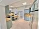 A kitchen with painted cabinets, island, stainless steel appliances, and wood flooring at 4218 S Lockwood Ridge Rd, Sarasota, FL 34231