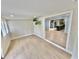 Open-concept living room with hardwood floors and a view into the modern kitchen at 4218 S Lockwood Ridge Rd, Sarasota, FL 34231