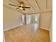 Light filled Living room boasts neutral walls, modern fan and hardwood floors at 4218 S Lockwood Ridge Rd, Sarasota, FL 34231