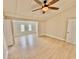 Bright living room featuring new flooring, modern ceiling fan, and a seamless flow into the adjacent room at 4218 S Lockwood Ridge Rd, Sarasota, FL 34231